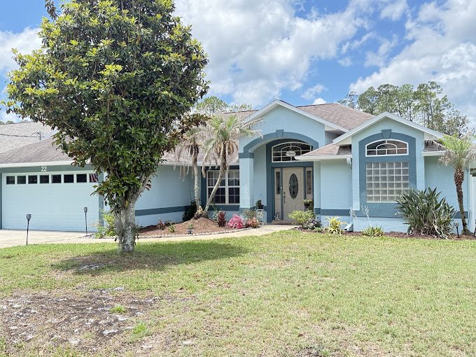 Blue and gray single-story home after exterior painting