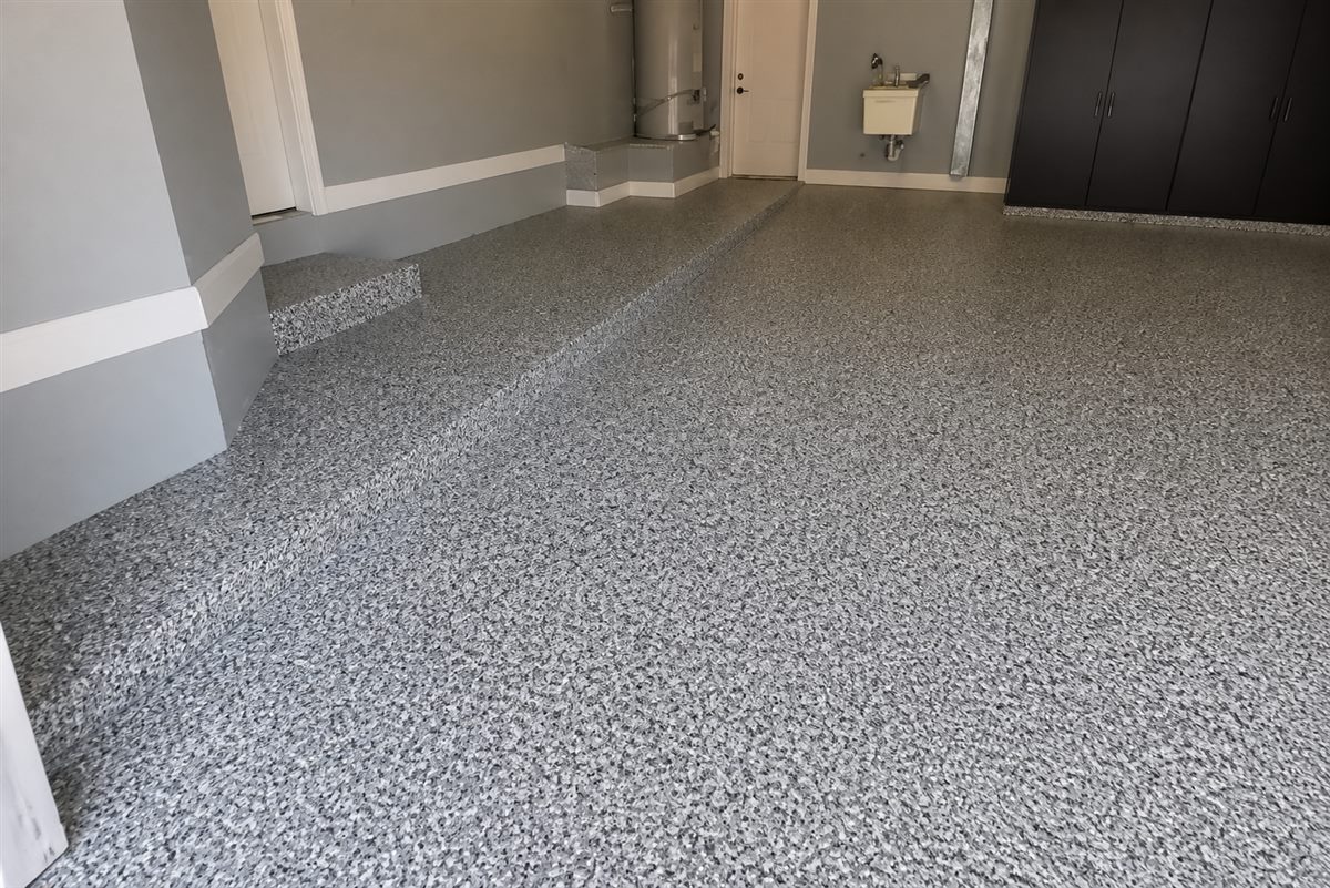 Gray decorative flake epoxy floor in a finished residential garage